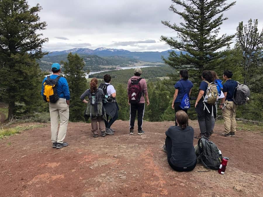 students standing in front of scenic view in Yellowstone National Park